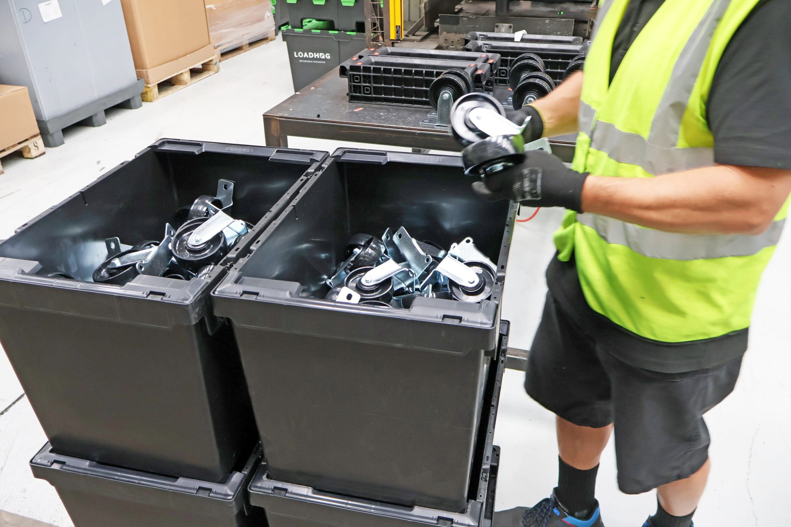 Omnimax bail arm tote being used in a manufacturing factory