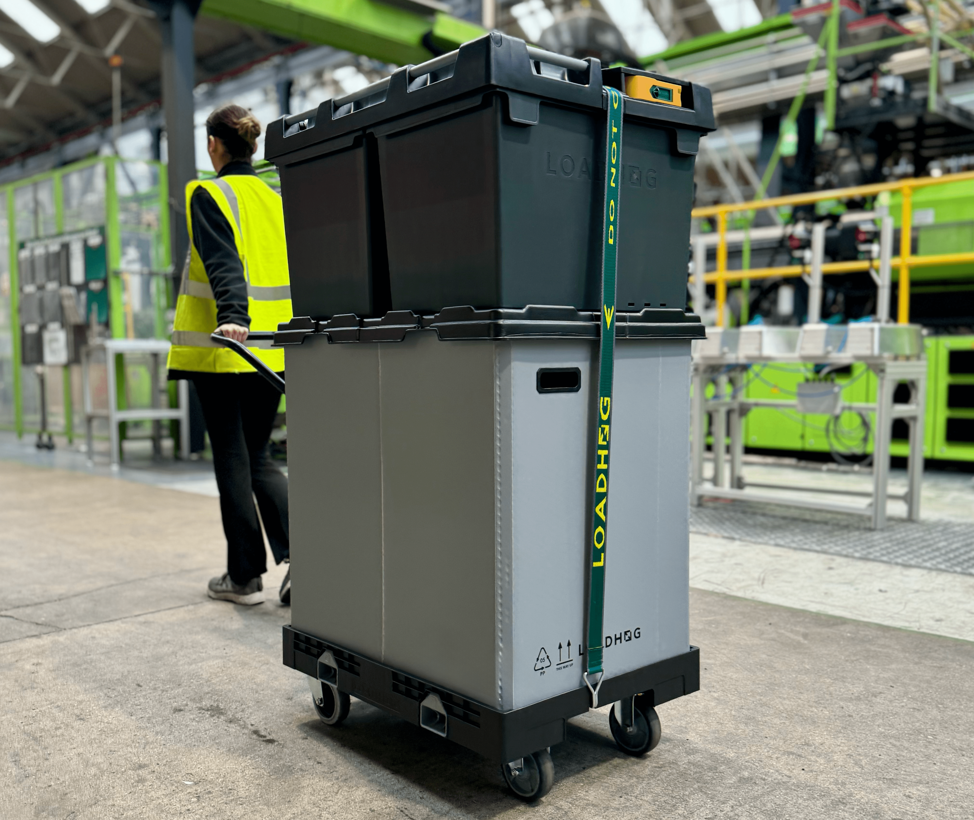 wheeled container system being pulled in warehouse