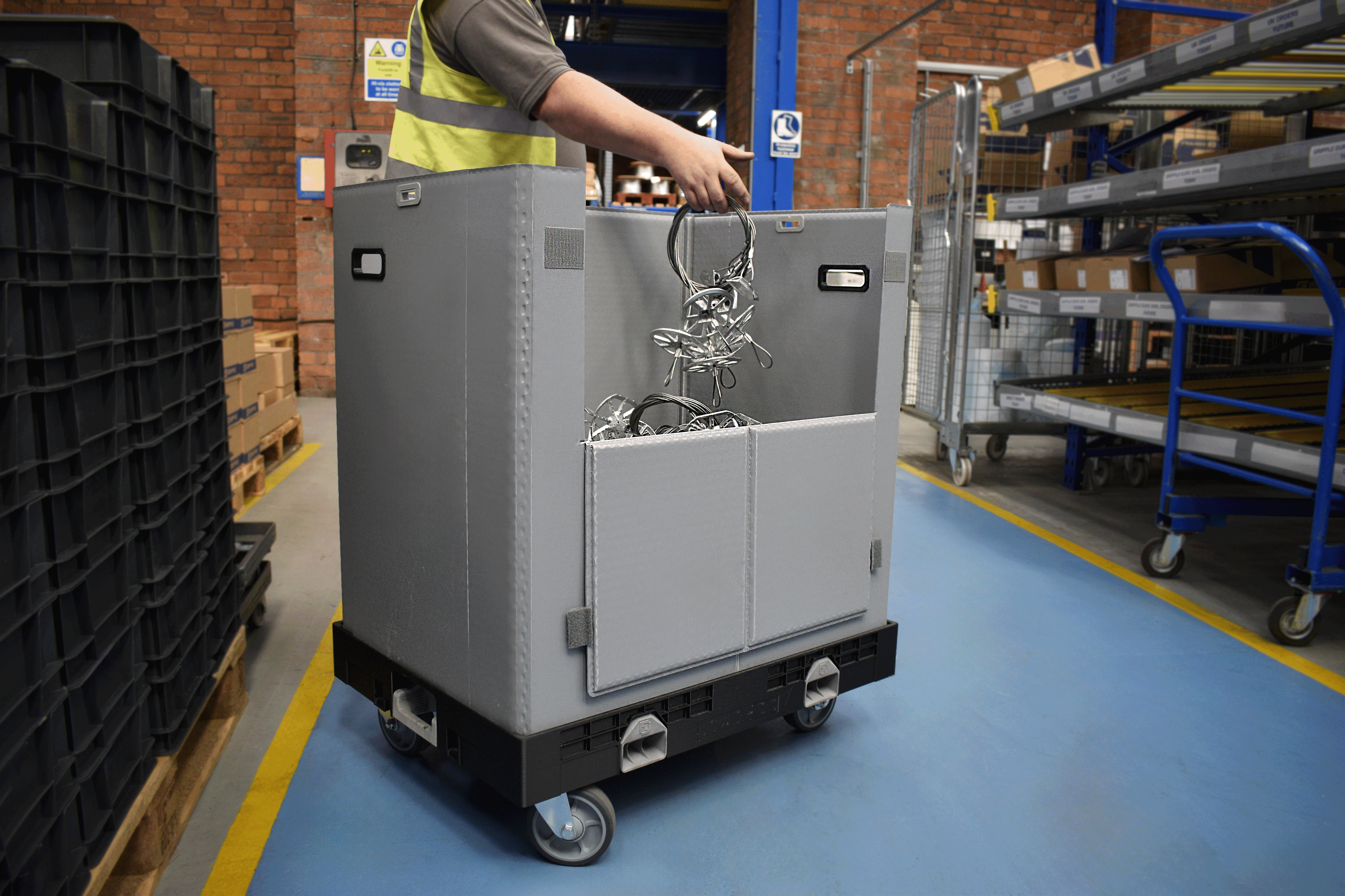 wheeled container packaging system being used in manufacturing