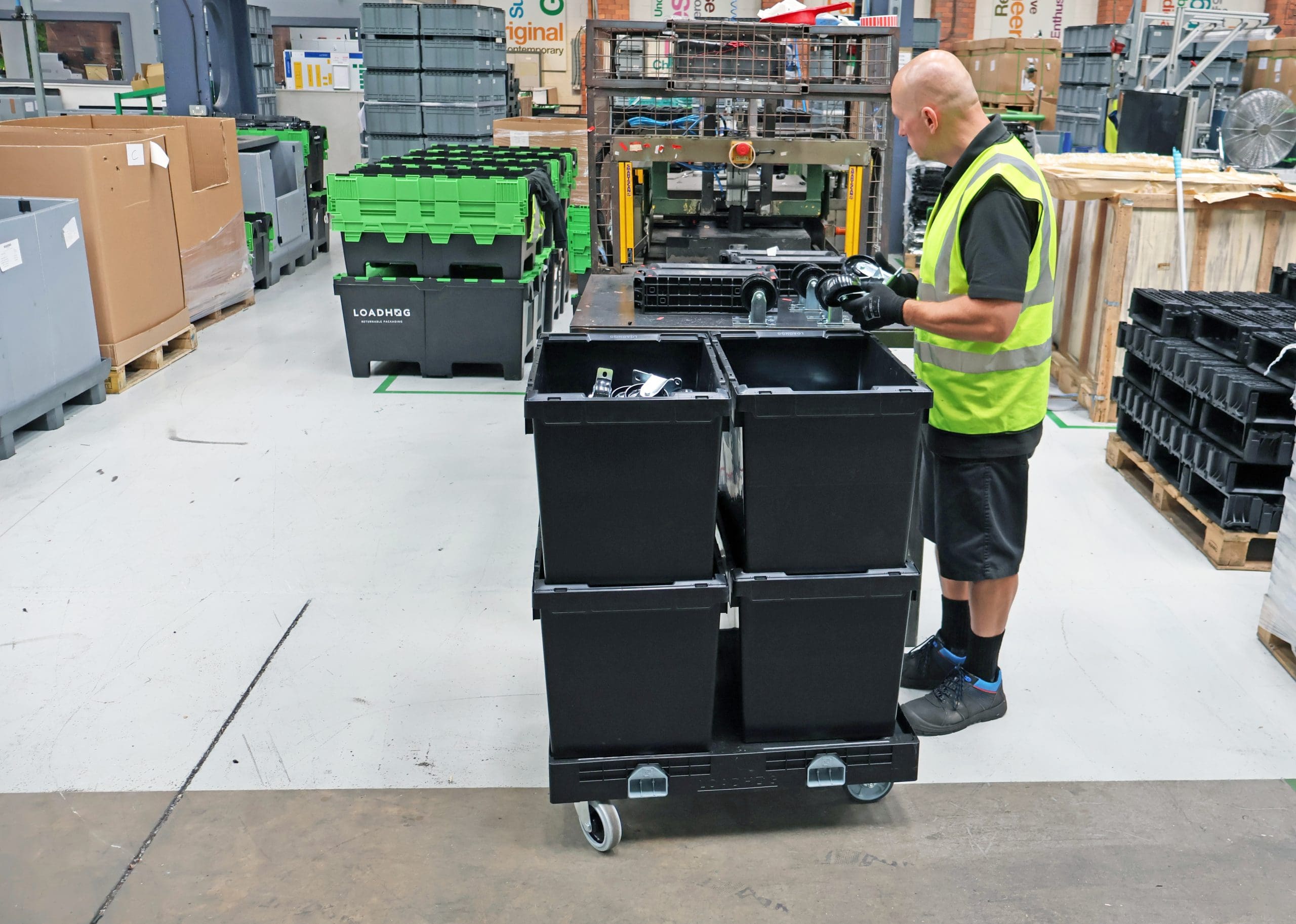 bail arm tote and wheel platform being used by warehouse operative