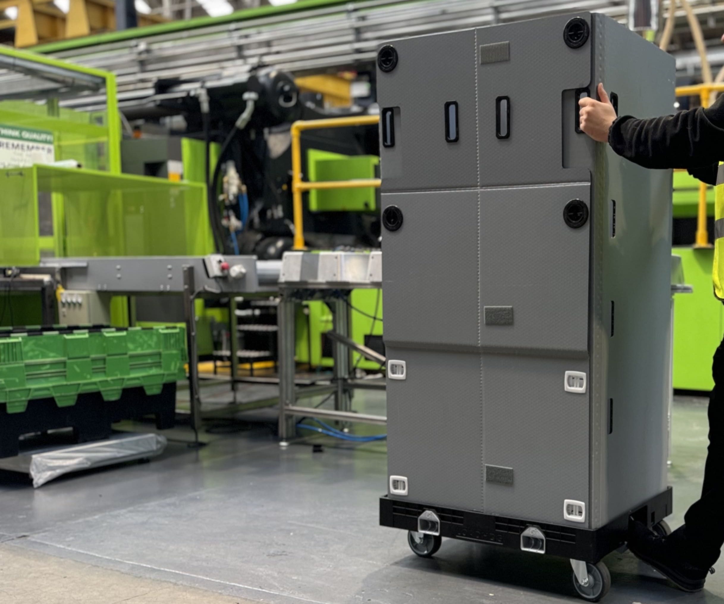 wheeled container being pushed in factory