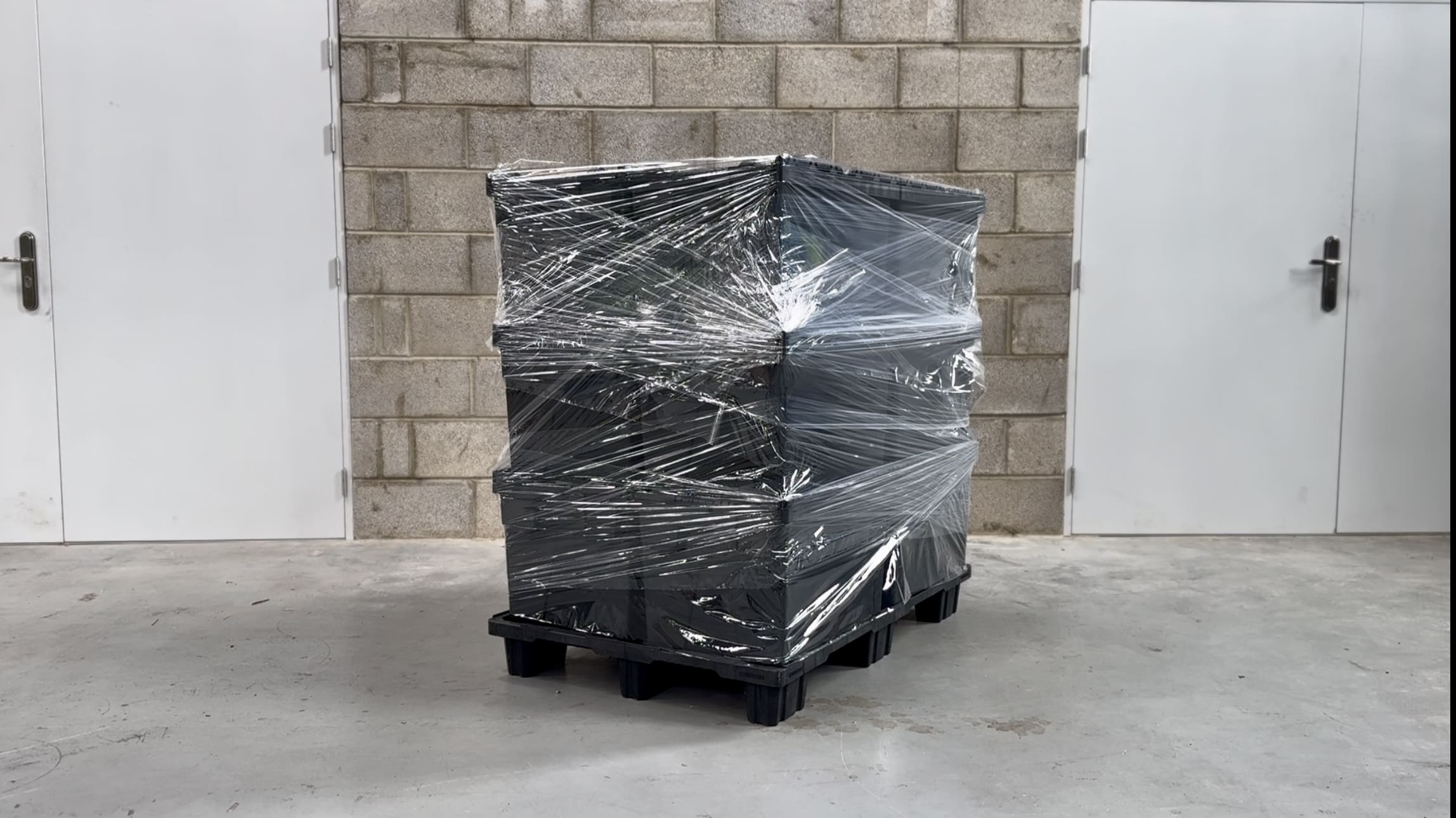 pallet and packaging totes being secured with stretch wrap