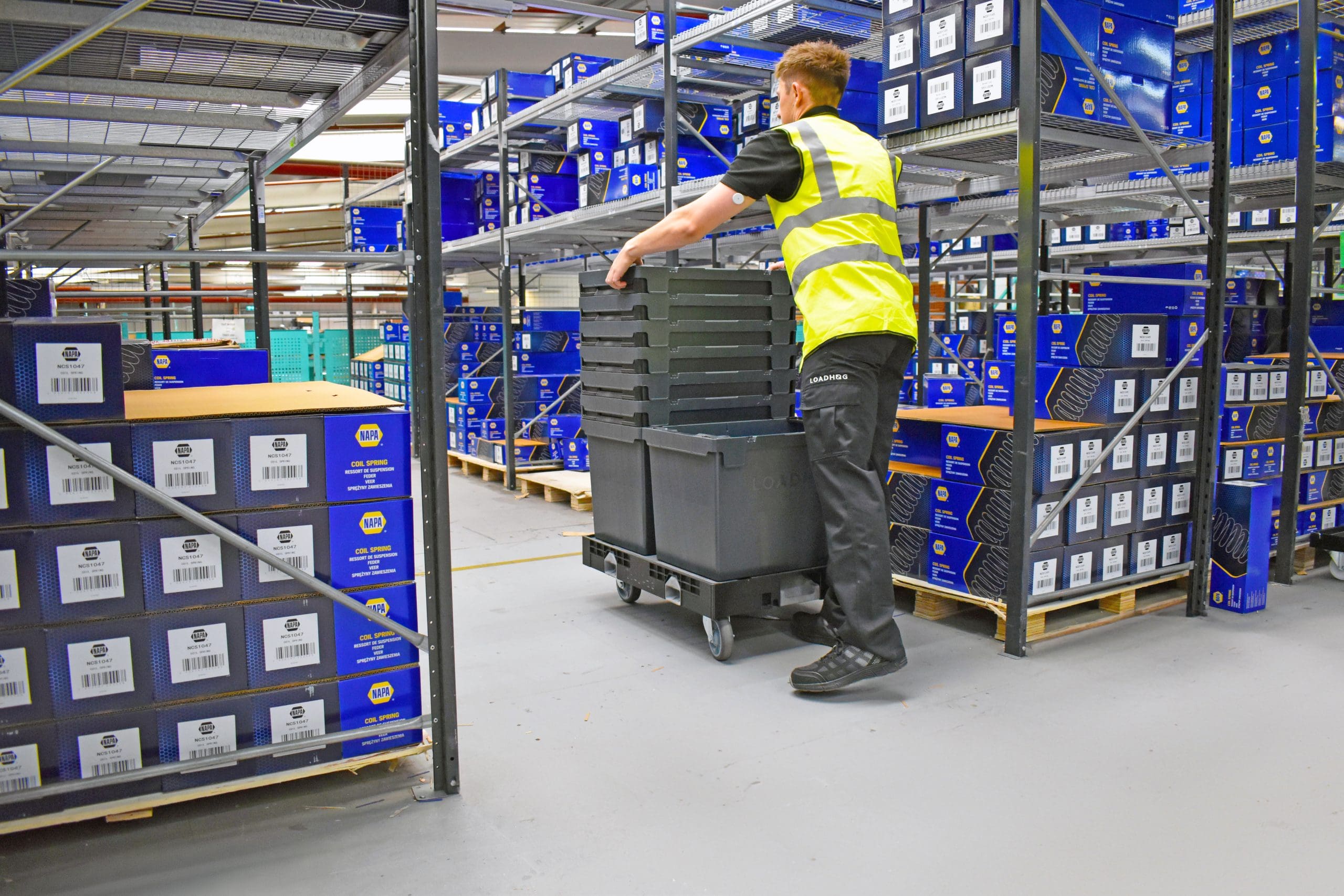 bail arm tote and wheeled platform being used in retail distribution centre